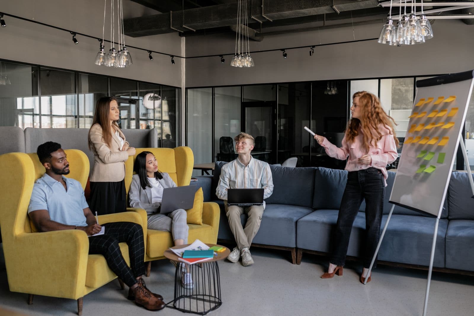 Colleagues reviewing ideas during a presentation in an office lounge